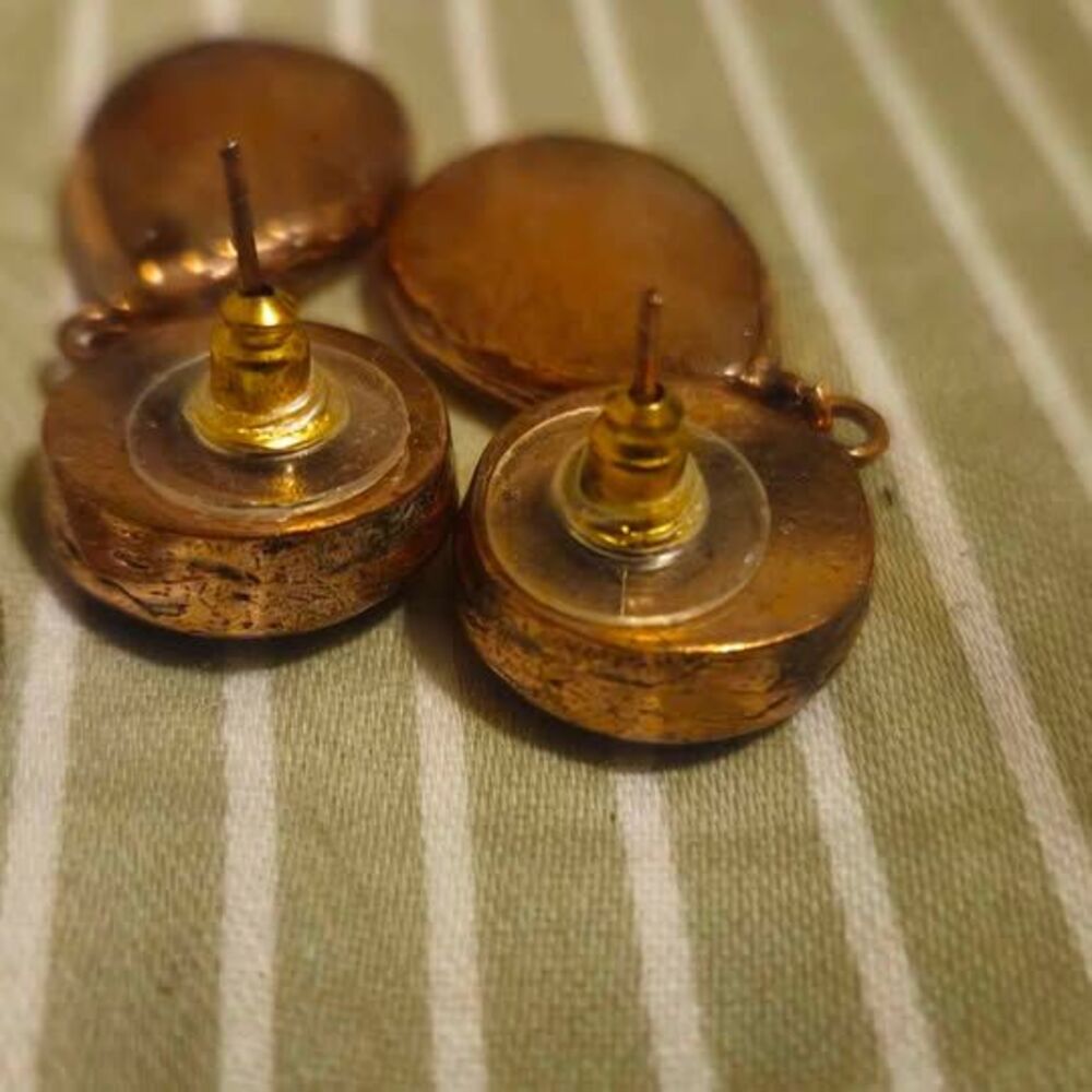 Copper drop earrings feature a top circular green-gray stone